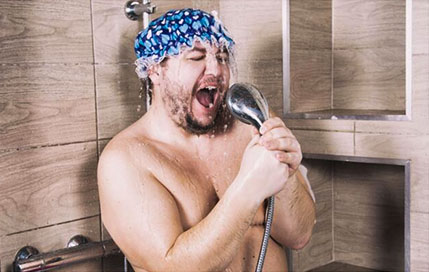 A fat guy singing in while bathing